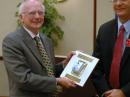 Dave Sumner, K1ZZ (left) receives the AMRAD "BPL Spoils" award from Brennan Price, N4QX, at the July 2010 ARRL Board meeting.